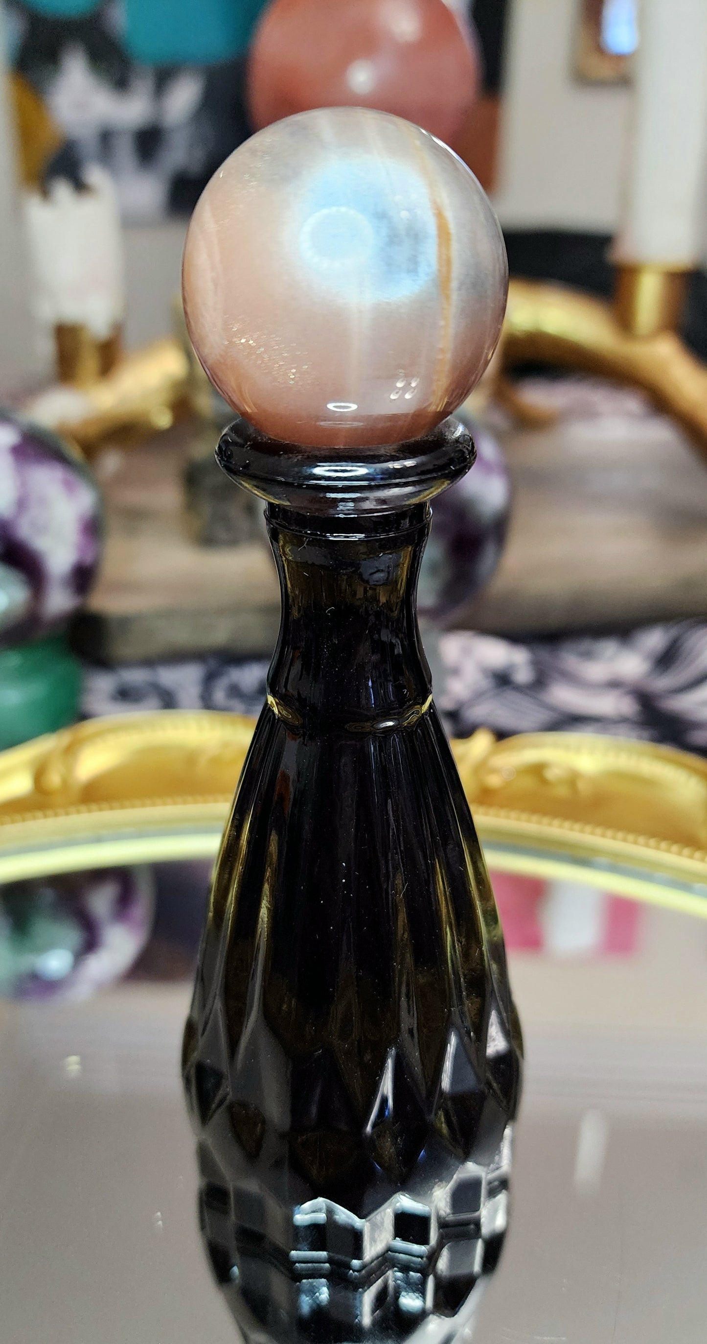 Black Sunstone Sphere on a Black Vase A
