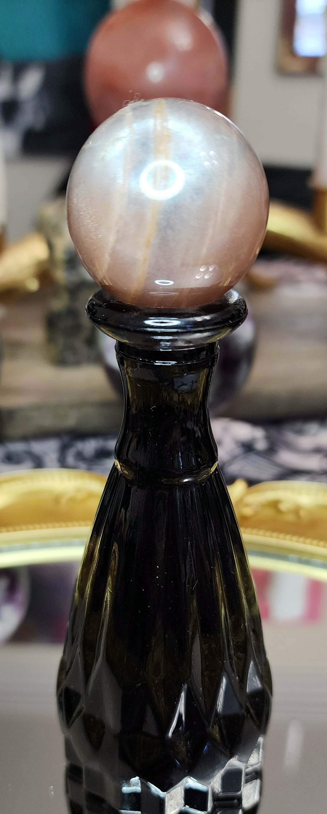 Black Sunstone Sphere on a Black Vase A