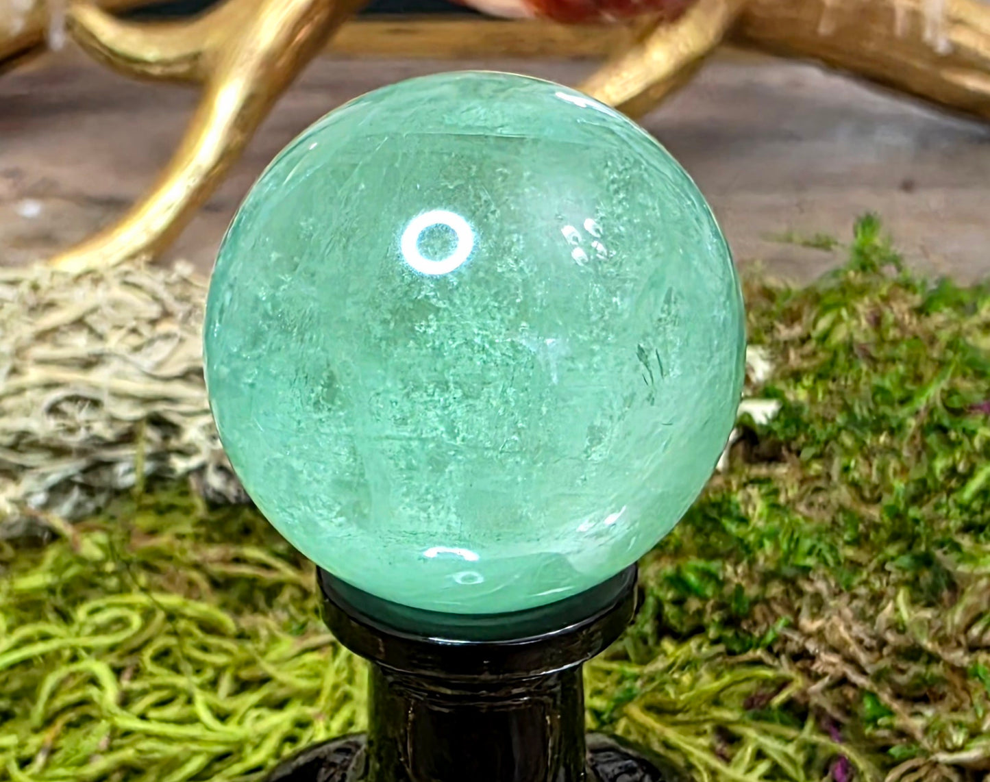 Green Fluorite Sphere on a Black Vase A
