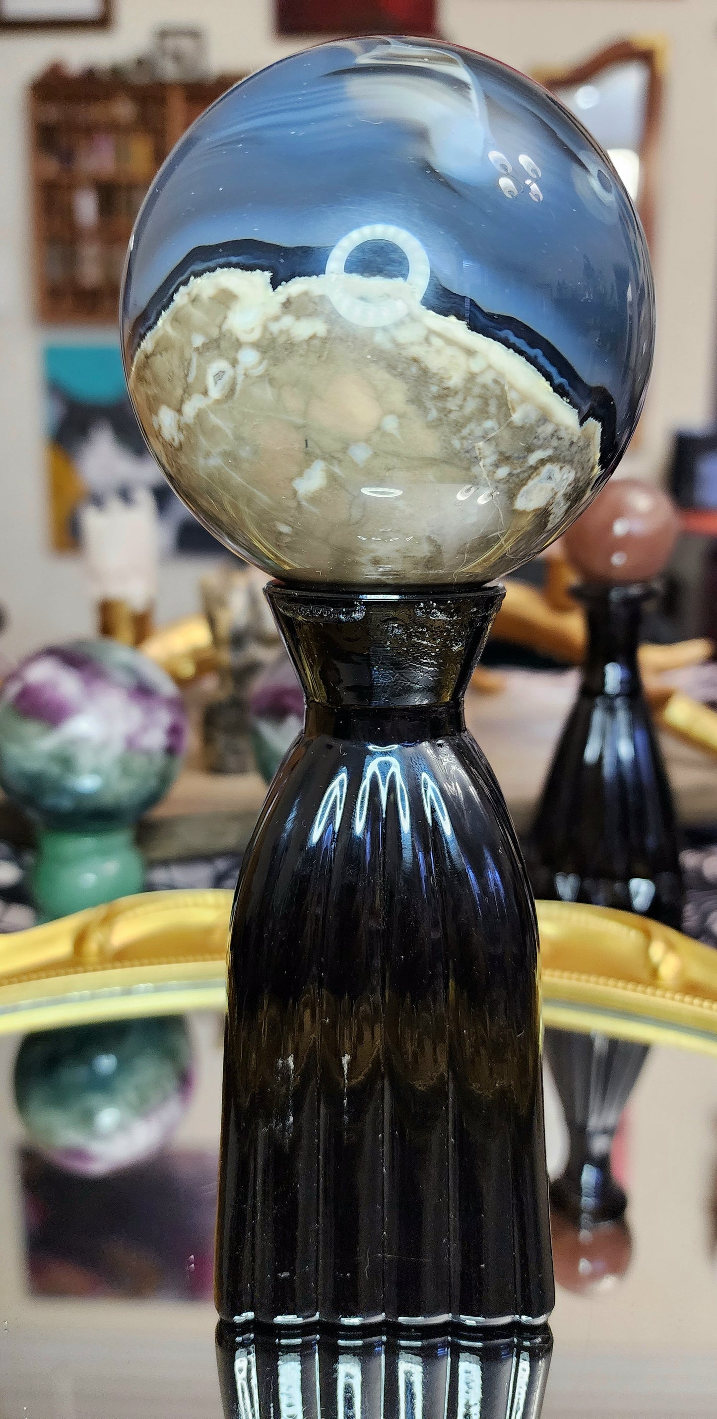 Volcano Agate Sphere on a Black Vase