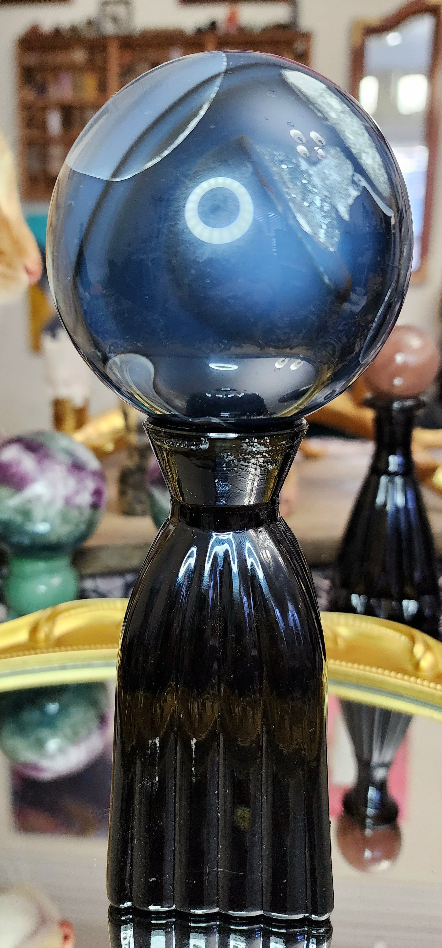 Volcano Agate Sphere on a Black Vase