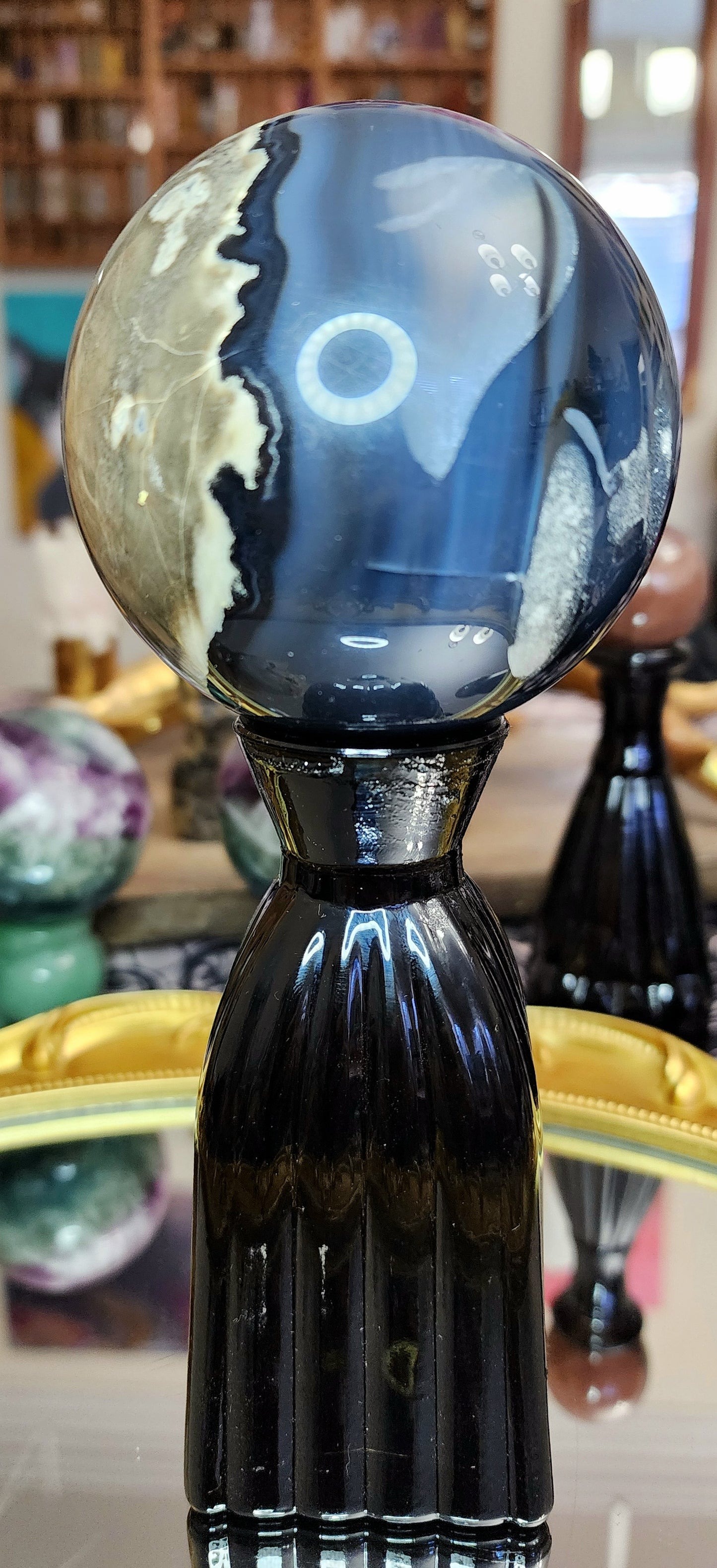 Volcano Agate Sphere on a Black Vase