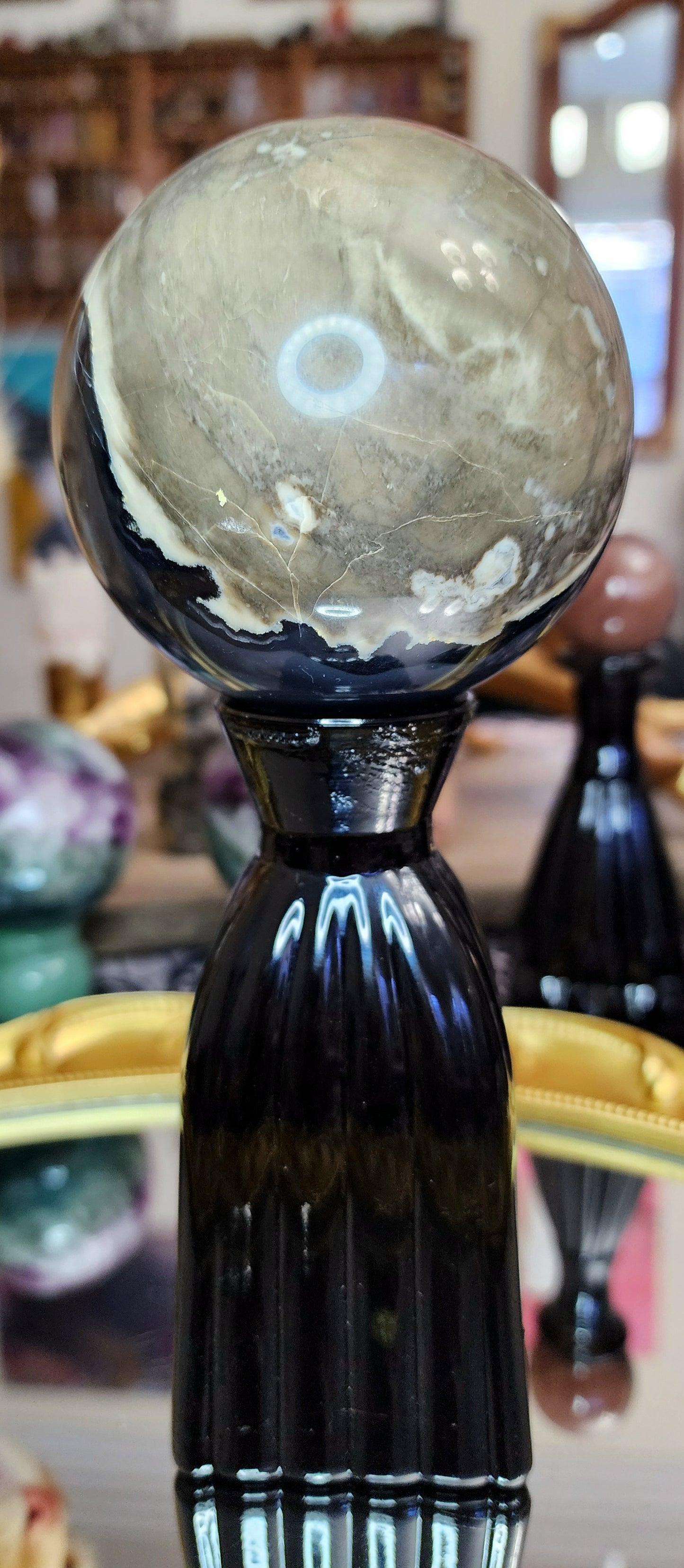 Volcano Agate Sphere on a Black Vase