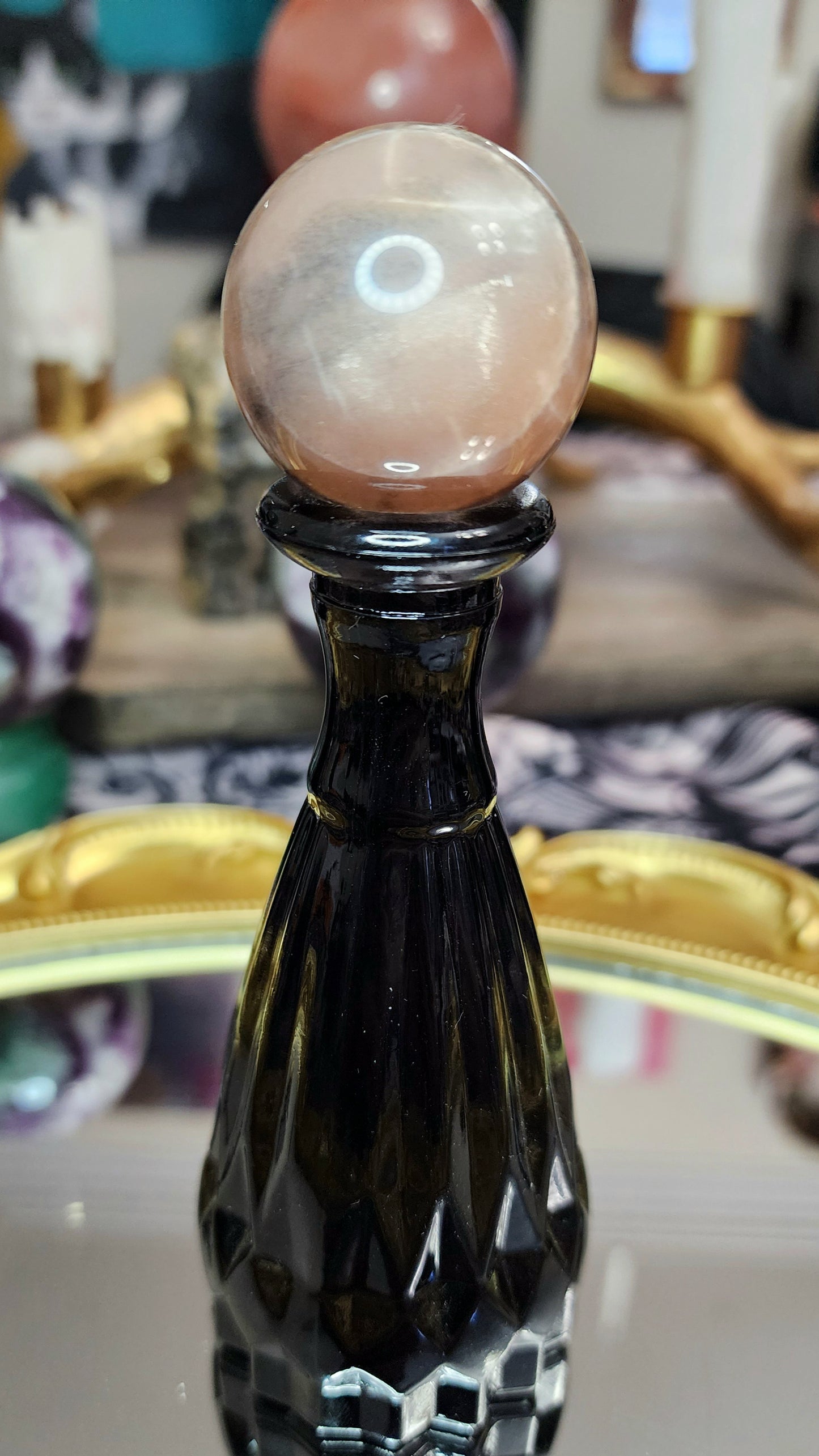 Black Sunstone Sphere on a Black Vase A