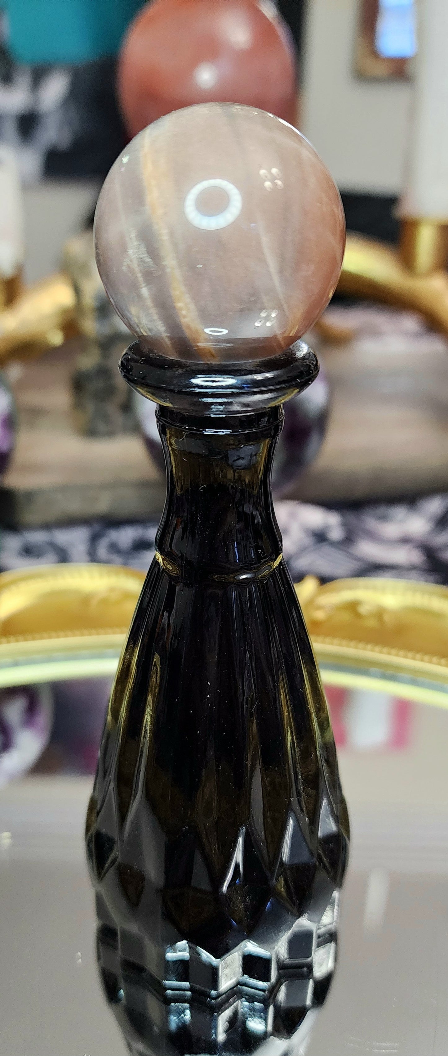 Black Sunstone Sphere on a Black Vase A